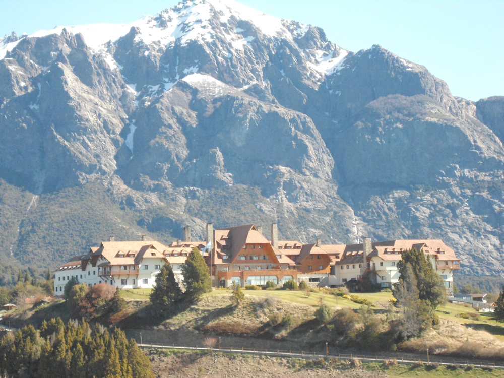 Panoramic view of the historic Llao Llao Hotel, nestled between mountains and lakes.