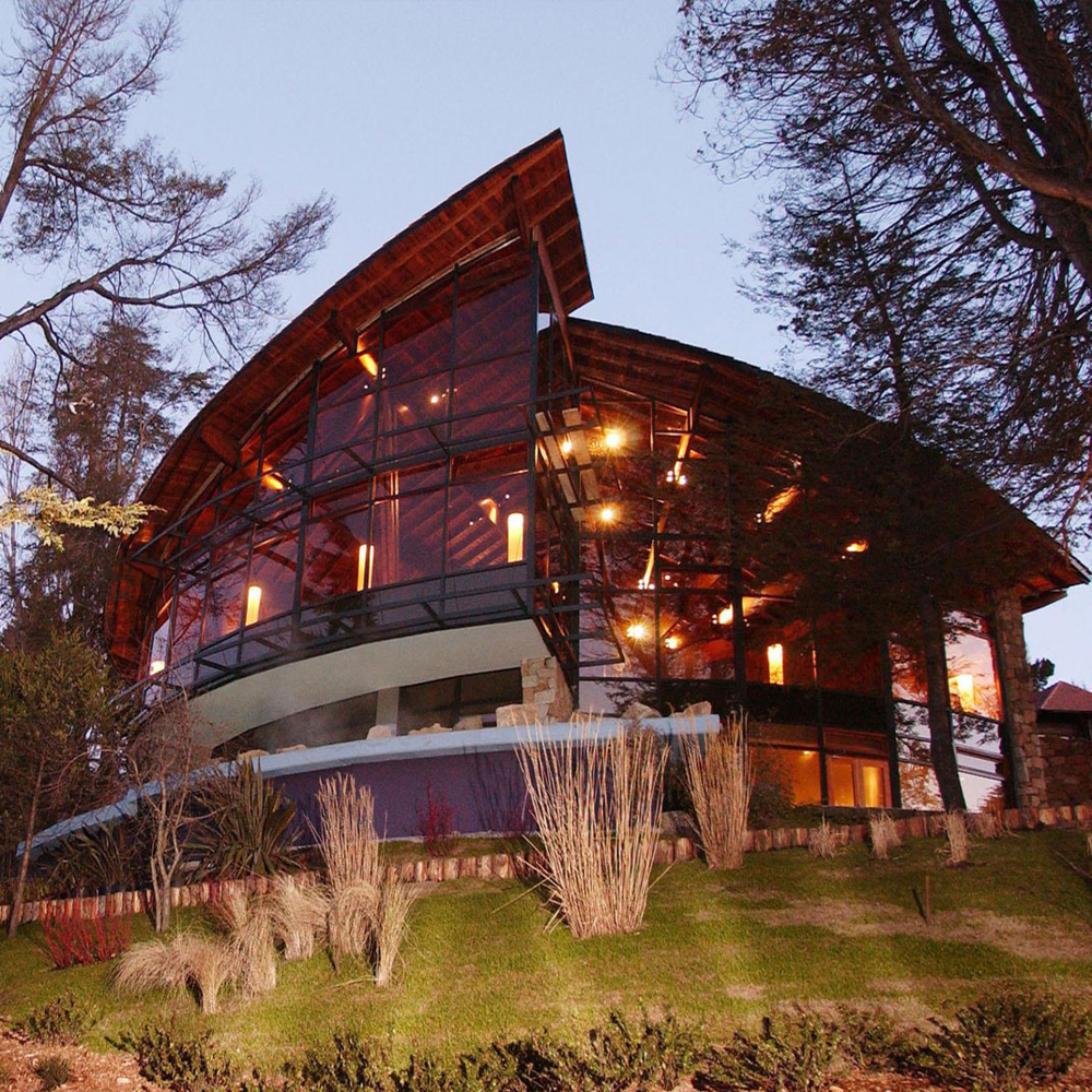 Panoramic view of the historic Llao Llao Hotel, nestled between mountains and lakes.